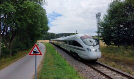 FRMCS test environment successfully in use in digital test field. The picture shows a train on traintracks with a FRMCS antenna in the background.