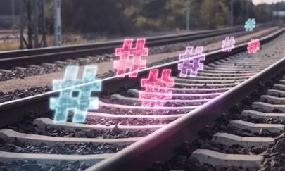 Moodbild der Digitale Schiene Deutschland Hier sehen Sie ein Stimmungsbild der Digitalen Schiene Deutschland mit Gleisen und leuchtenden Hashtags.
