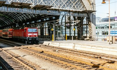 The photo shows Dresden central station with an arriving train